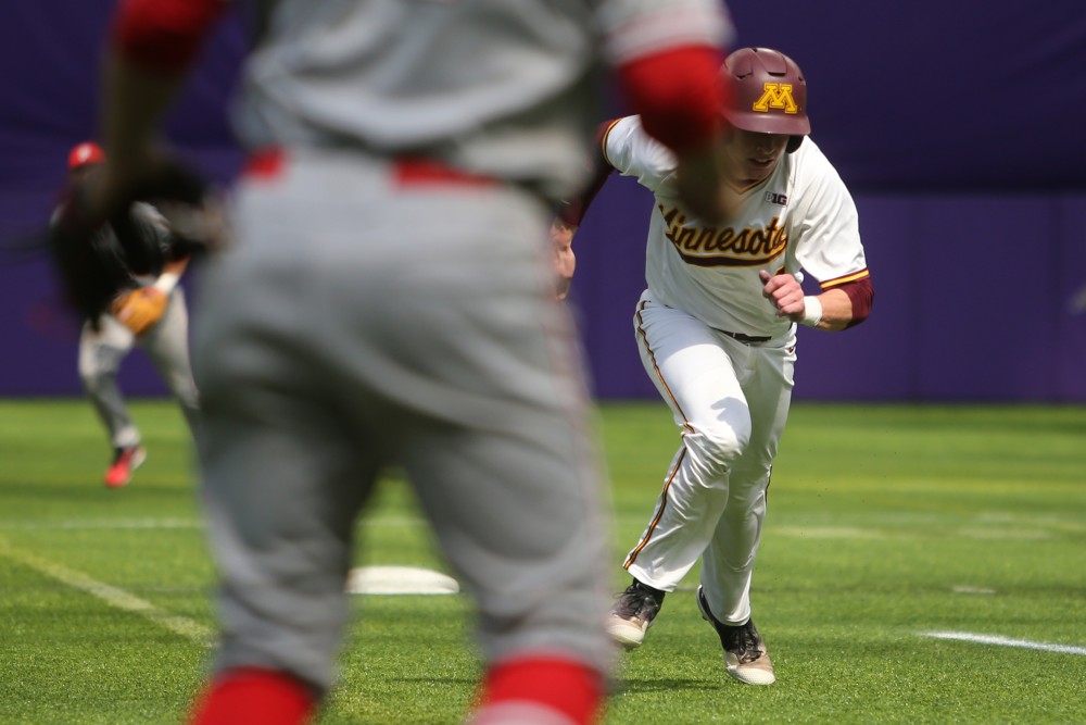Catcher Eli Wilson runs to third base during the game against St. Johns University on Saturday, March 31 at U.S. Bank Stadium in Minneapolis. The Gophers won 6-3.