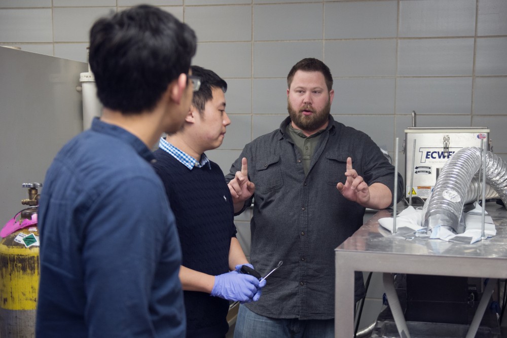 From left, Intense Pulsed Light technology researchers Peng Peng, Dongjie Chen and Erik Anderson discuss possible modifications they can make to their design in the Food Science and Nutrition Building on Tuesday, April 4. 