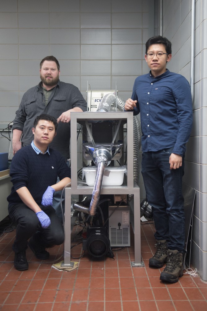 From left, researchers Erik Anderson, Dongjie Chen and Peng Peng pose with their Intense Pulsed Light technology in the Food Science and Nutrition Building on Tuesday, April 4. 