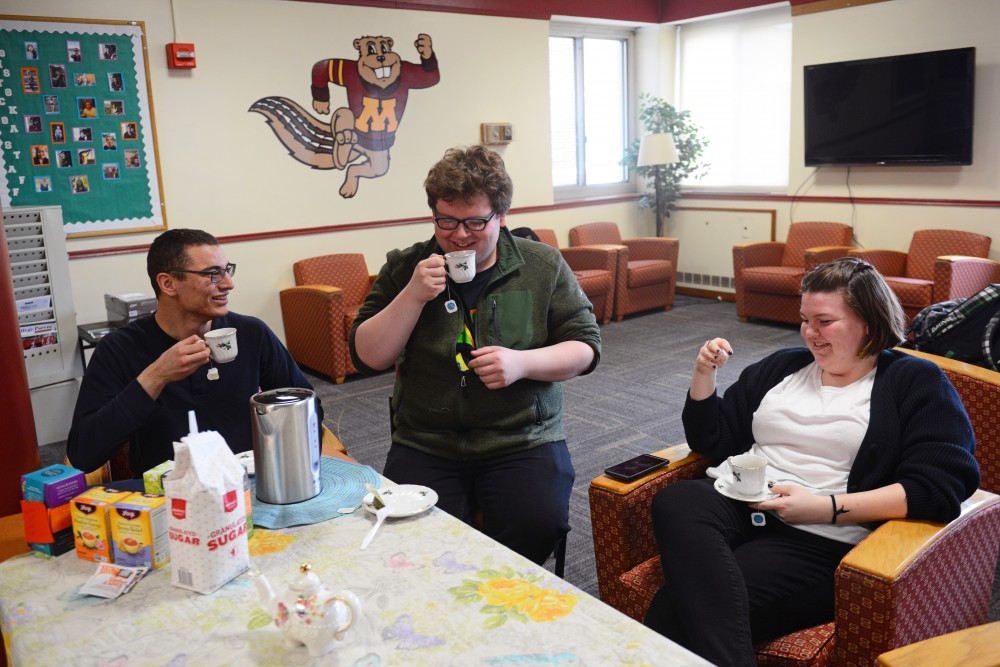 Zachariah Little, center, engages with Daymian Snowden, left, and Lauren Foley at his tea club in Comstock Hall on Wednesday, April 11. He runs this club every Wednesday and Friday at 4 p.m.