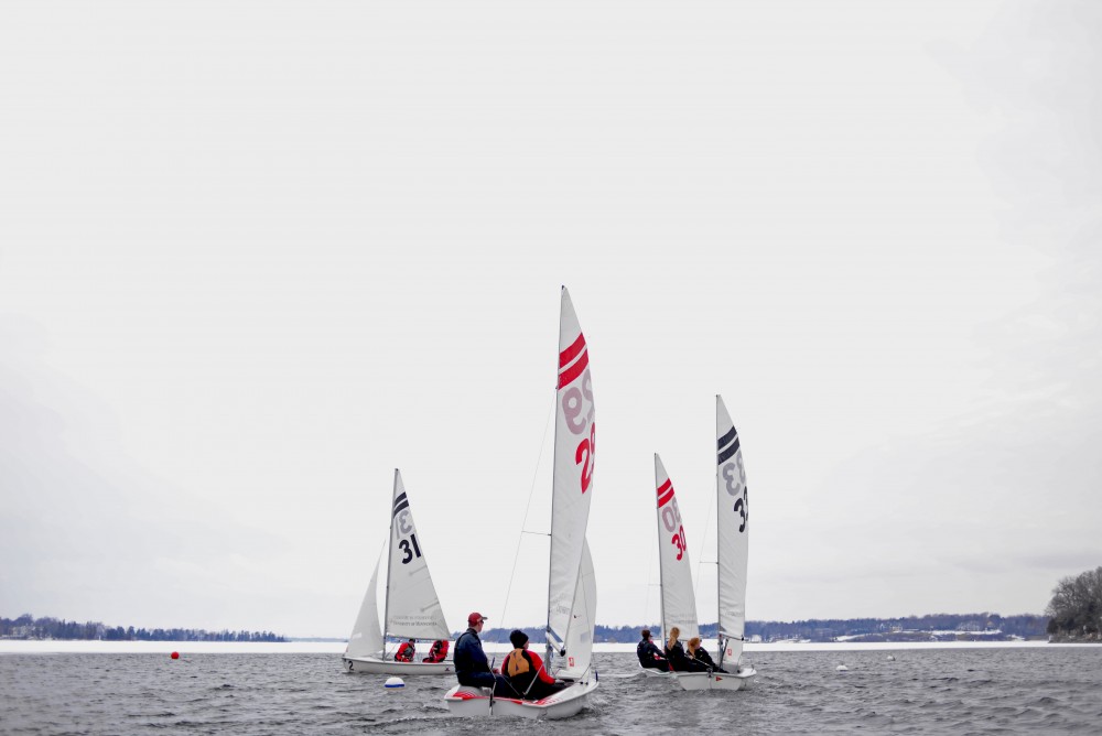 The University of Minnesota sailing team sail in a small opening of the de thawed Wayzata Bay.  