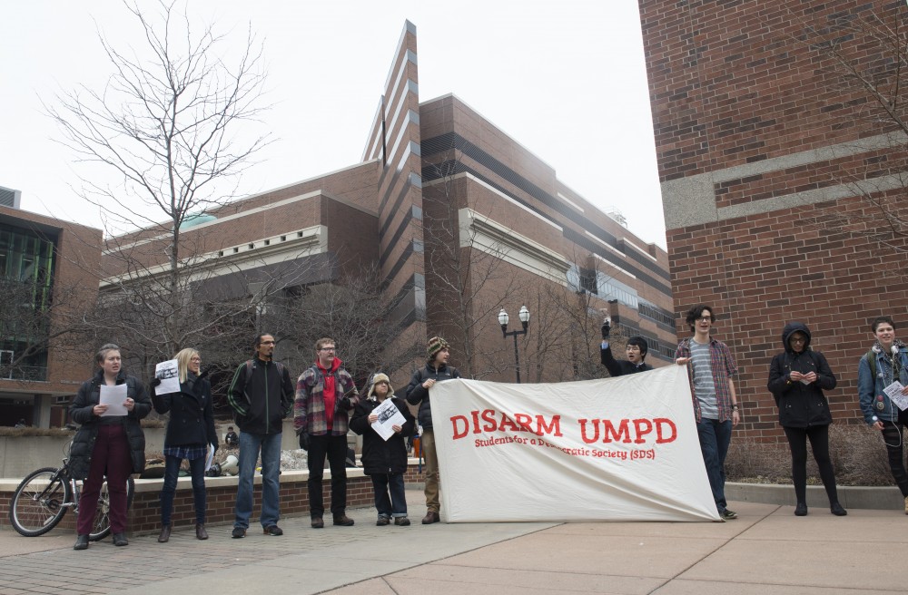 Members of Students for a Democratic Society stand outside of UMPD headquarters voicing concerns about the quantity of weapons at the departments disposal on Thursday, April 12.