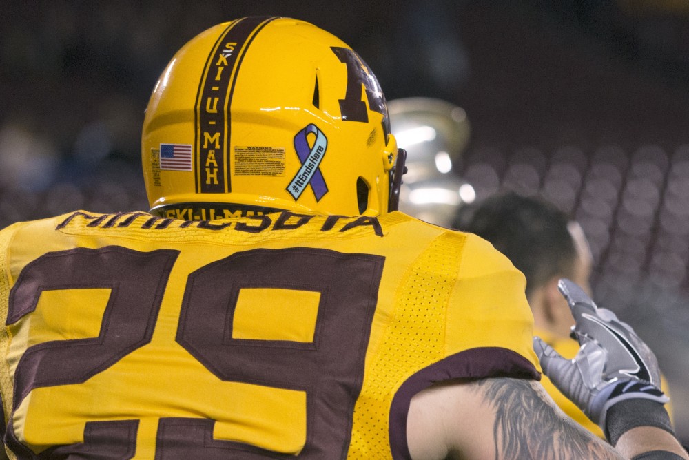 Gophers football players wore ribbons on their helmets in support of MSAs It Ends Here campaign during the spring game on Thursday, April 12 at TCF Bank Stadium. 