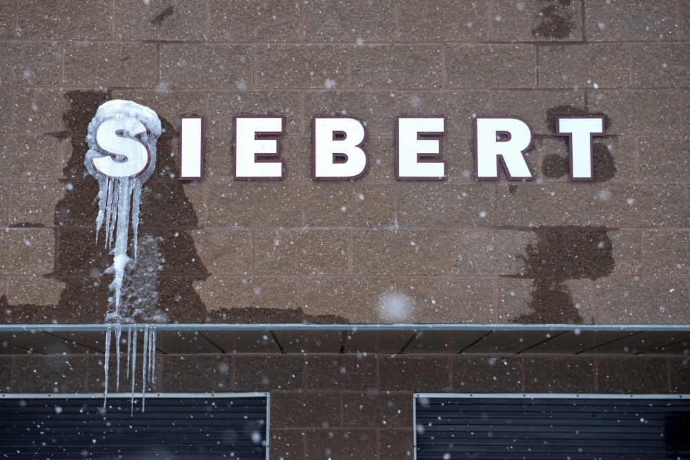 The sign above the concession stand at Siebert Field gathers icicles during a blizzard on Sunday, April 15. Blizzard warnings and low temperatures have caused several sports at the University to cancel and postpone events. 