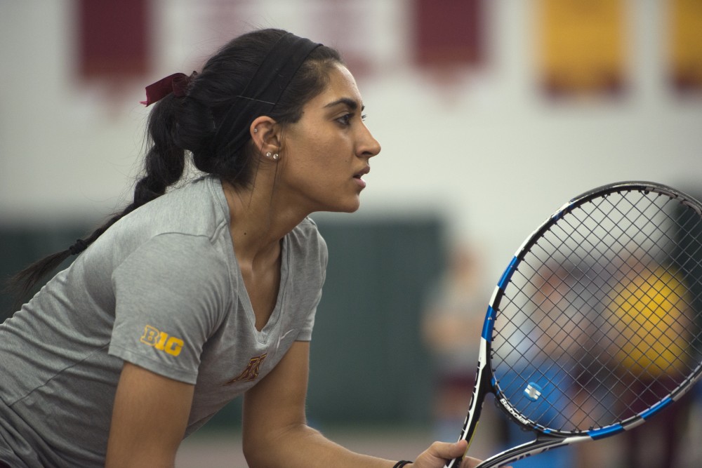 Senior Mehvish Safdar prepares to receive a serve from the University of Northern Iowa at the Baseline Tennis Center on Friday, Jan. 26. 
