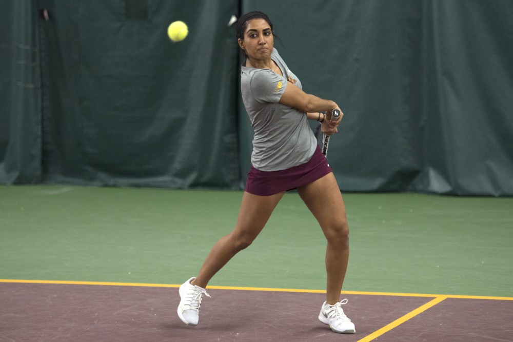 Senior Mehvish Safdar returns the ball to the University of Northern Iowa at the Baseline Tennis Center on Friday, Jan. 26. 