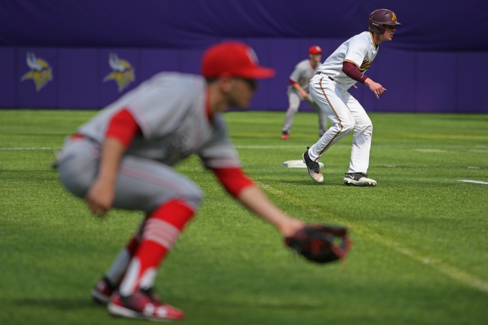 Catcher Eli Wilson makes his way to third base during the game against St. Johns University on Saturday, March 31, 2018 at U.S. Bank Stadium.