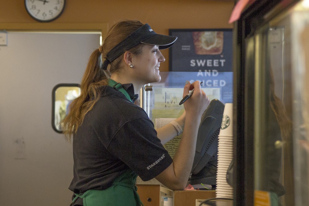 Starbucks employee Hanna Okhrimchuk takes down a customers order.