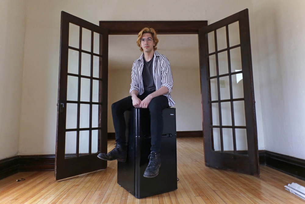 Computer science major Jeremiah Michalik poses for a portrait in his empty apartment on Tuesday, April 24 in Minneapolis. Michalik struggles to pay his $500 monthly rent, so hes adding a commute to school and moving to Crystal, Minnesota to cut costs.