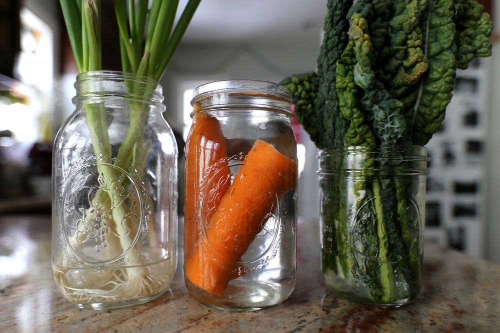 Sustain Yo Self designs strategies for readers to make vegan and zero-waste lifestyles, such as preserving produce in water. The Wood sisters produce is displayed in their kitchen on Wednesday, April 18 in Minneapolis.