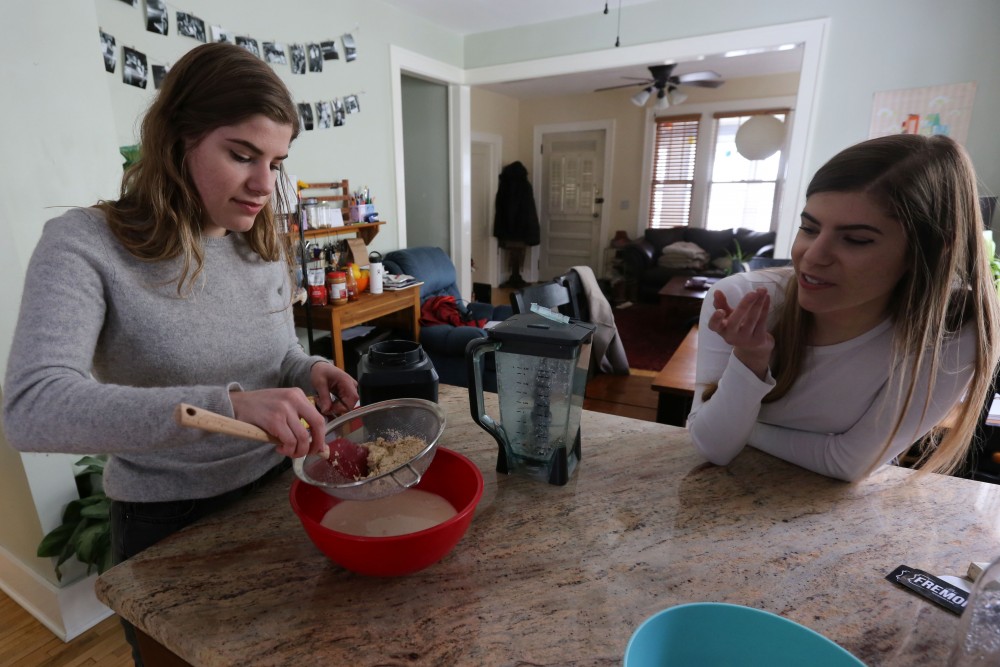 Sophie Wood and Geevie Wood make homemade oat milk on Wednesday, April 18 at their house in the Como neighborhood. The twin sisters started the blog, Sustain Yo Self to share and promote their zero-waste and vegan lifestyle.