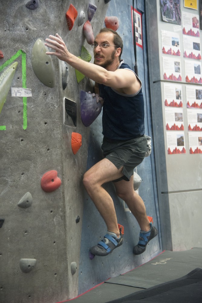 Jonathan Brown climbs on the Center for Outdoor Adventure’s bouldering wall.
