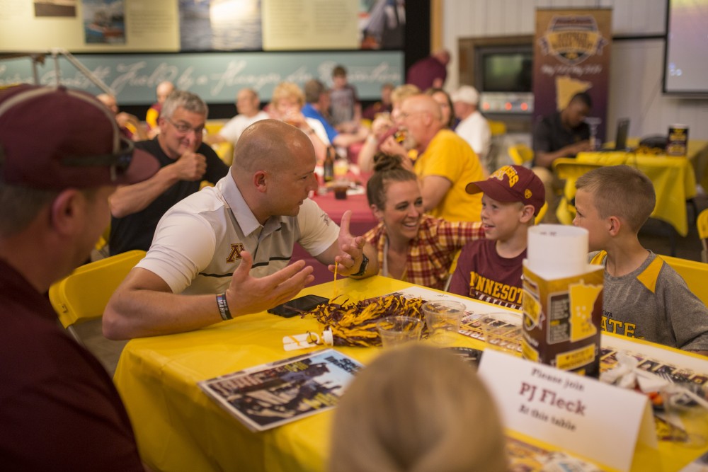 P.J. Fleck converses with Macaille Mahoney Hafner, left,Fynn Bakke and Henry Mayer at Flecks table during the Gopher Road Trip at the Legacy of the Lakes Museum on Thursday, May 24 2018 in Alexandria, Minnesota. 