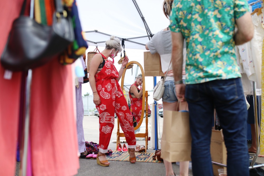 Alexandria Cochran tries on a red overall outfit at the launch of the Minneapolis Vintage Market on Sunday, June 24.