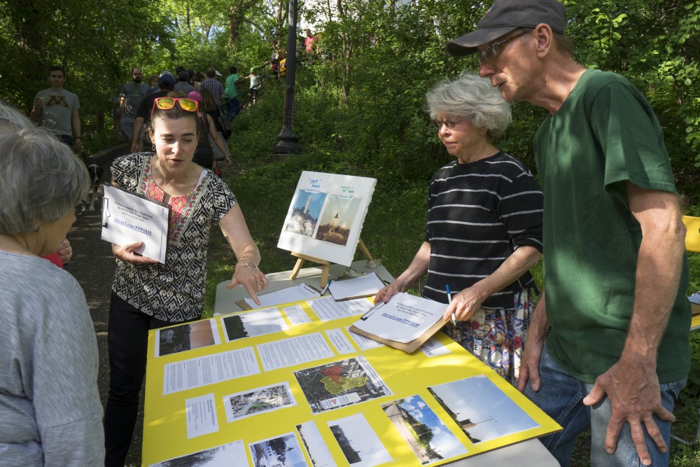 Neighborhood activists Elizabeth Rome, left, Susan Warner and George Hansen showing the potential impact that proposed developments will have on the area surrounding Witchs Hat Tower. The Prospect Park Association is concerned with the height of these developments, as Witchs Hat lies on the tallest natural point in Minneapolis.