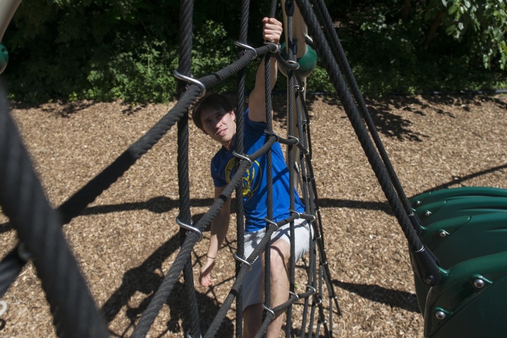 Eric Middleton trains at a playground on the Saint Paul campus on Monday, July 16. Middleton is participating in American Ninja Warrior Season 10.