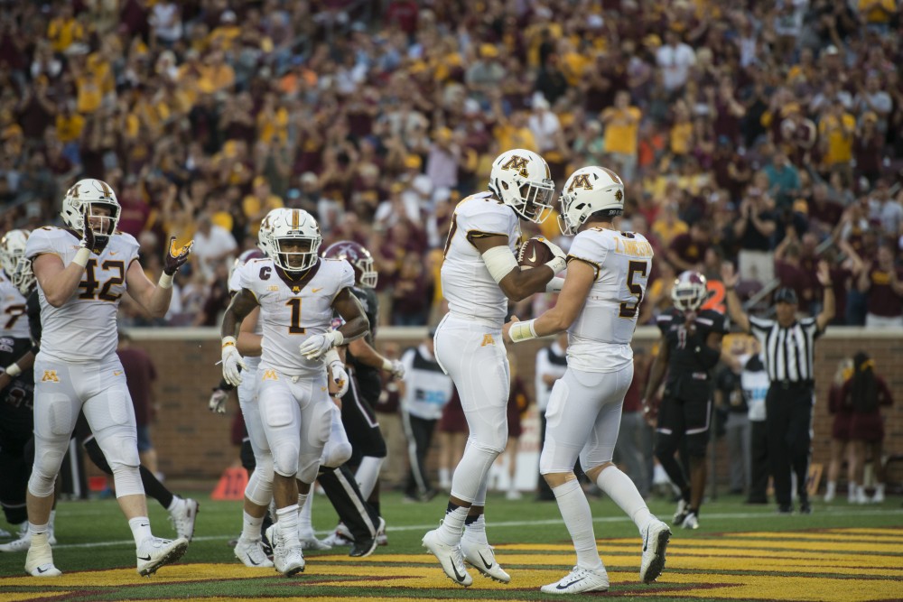 Seth Green celebrates earning a touchdown with quarterback Zack Annexstad during the game against New Mexico on Thursday, Aug. 30 at TCF Bank Stadium. The Gophers won 48-10.