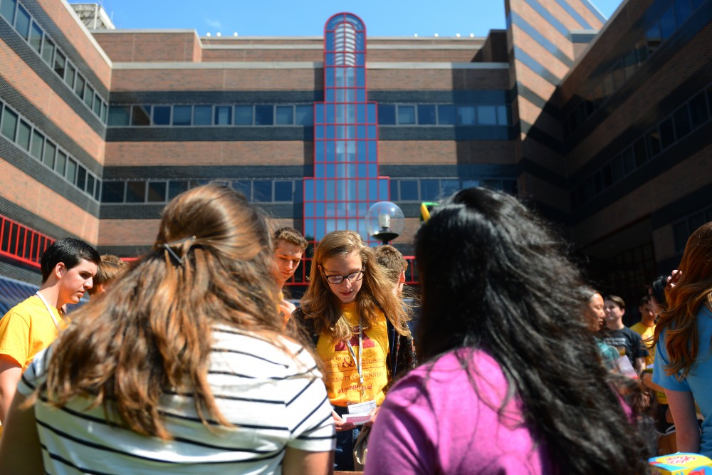 Freshman Elsa Forberger, center, speaks to Ellie Burns, left, and Ashmita Sarma about the Association for Computing Machinery for Women on Thursday, Aug. 30 outside of Lind Hall on East Bank. The College of Science and Engineering held an activities fair for incoming freshmen.