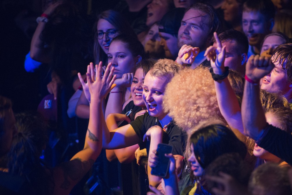 A member of the crowd high-fives a person who was escorted out of the photo pit for crowd surfing on Friday, Sept. 7 at the First Avenue Mainroom.