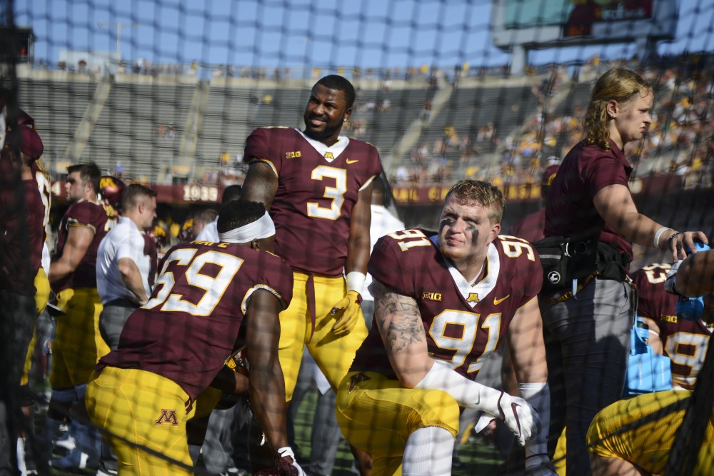 Players on the Gopher football team rest on the sidelines on Saturday, Sept. 15 at TCF Bank Stadium in Minneapolis.
