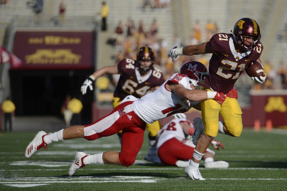 Runningback Bryce Williams is tackled during the game on Saturday, Sept. 15 at TCF Bank Stadium in Minneapolis.