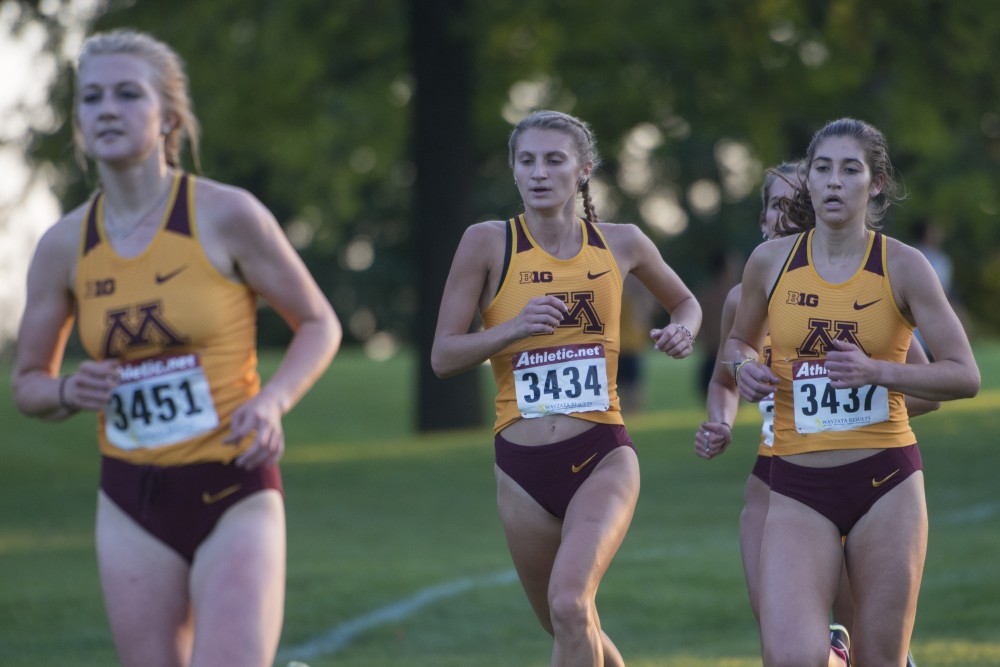 Redshirt sophomore Olivia Hummel, center, runs during the Oz Memorial on Friday, Sept. 7 at the Les Bolstad Golf Course.