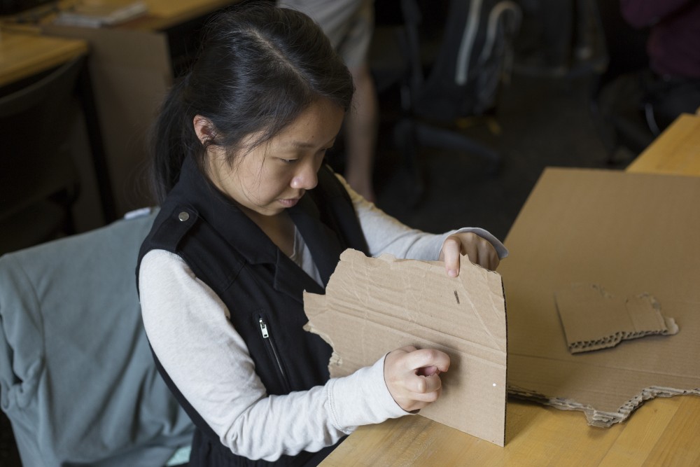 Architecture senior Belinda Xiong creates a cardboard model to represent a juvenile corrections facility at Rapson Hall on Monday, Sept. 24 on East Bank campus. Xiong and her class visited an adult correctional facility and a rehabilitation facility to learn firsthand how the spaces work.