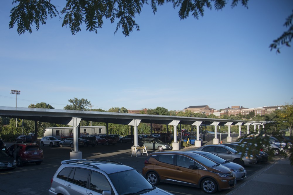 New solar panels shade the parking lot outside Humphrey School of Public Affairs on Wednesday, Sept. 26. The solar panels are part of a University effort to eliminate net carbon emissions by 2050.