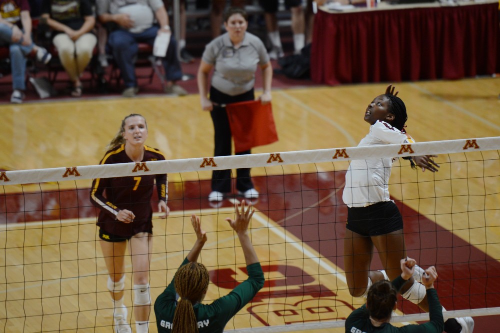 Freshman Adanna Rollins spikes a ball during the game on Thursday, Sept. 13 at Maturi Pavilion. Gopher womens volleyball defeated Green Bay in three straight sets.