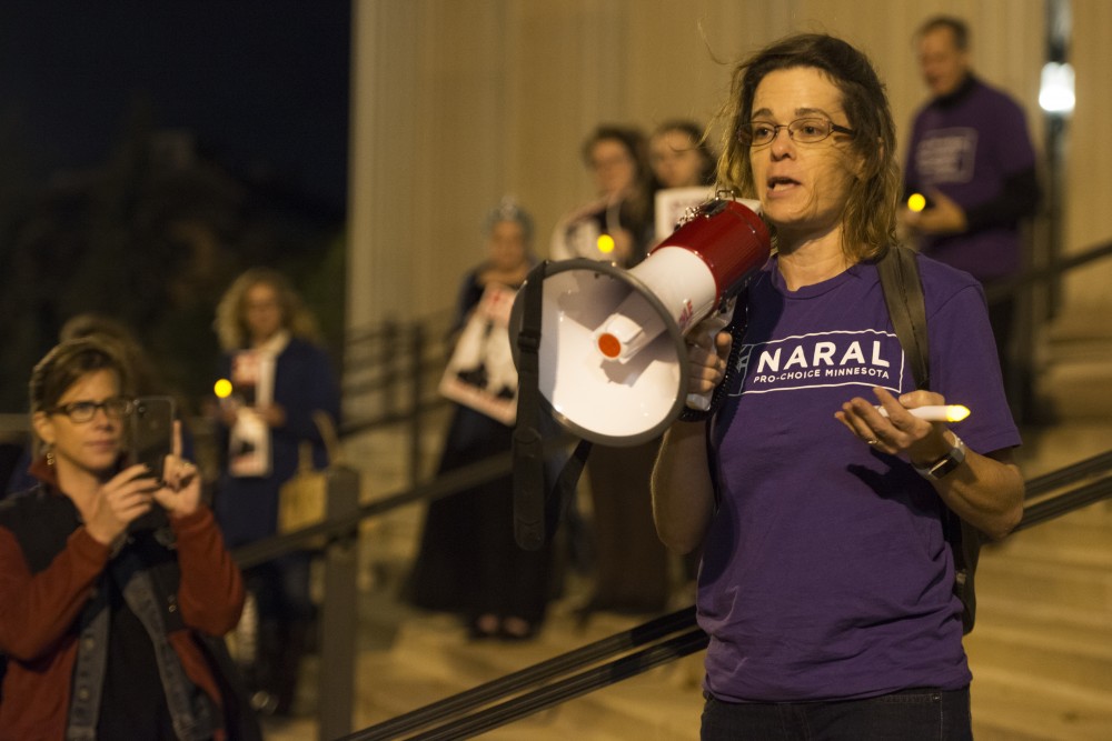 Executive Director of NARAL Pro-Choice America, Andrea Ledger, spoke to supporters of Dr. Christine Blasey Ford gathered at Northrop Plaza for a vigil on Wednesday, Oct. 3.