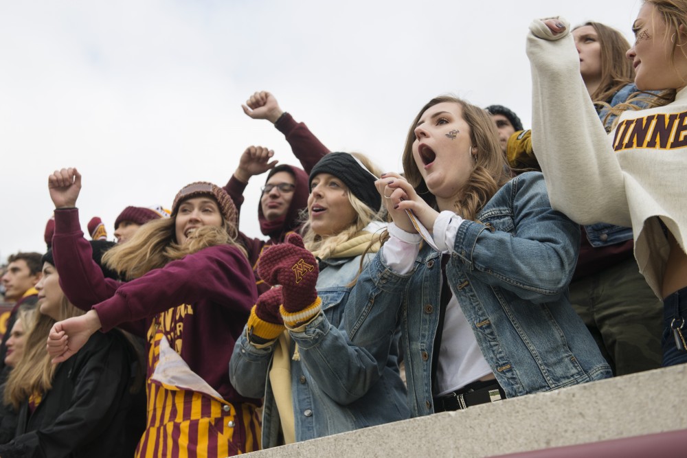 Students celebrate a touchdown on Saturday, Oct. 6 at TCF Bank Stadium. The Hawkeyes defeated the Gophers 48-31.  