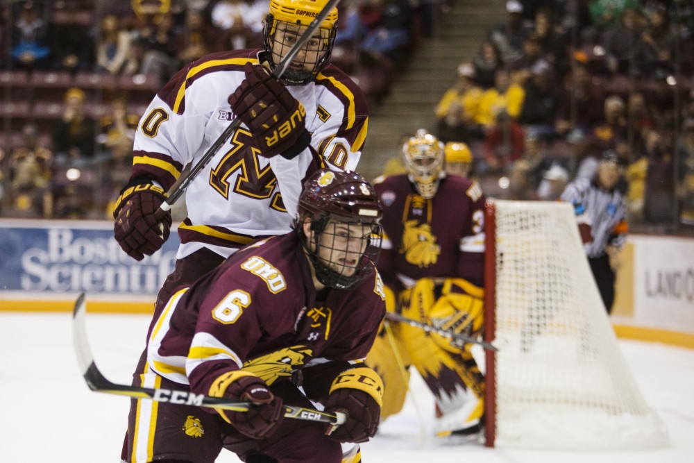 Senior forward Brent Gates Jr. eyes the puck as he tries to maneuver past the University of Minnesota Duluth during the game on Sunday, Oct. 7 at Mariucci Arena. The Gophers won 7-4.