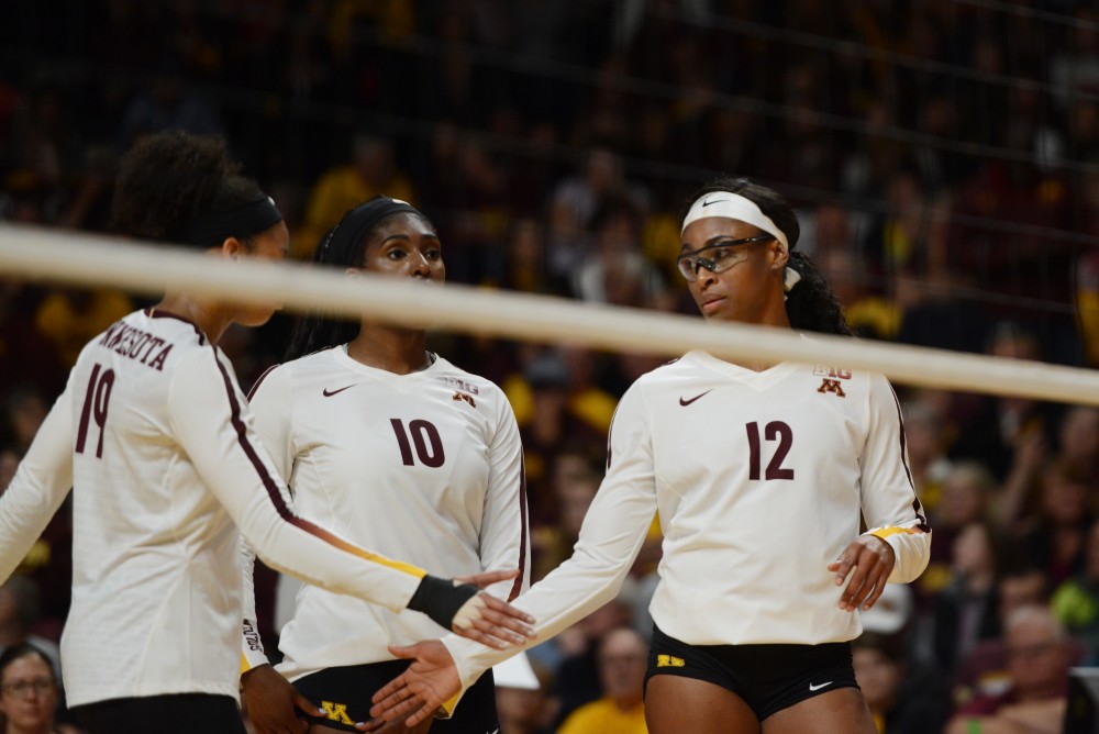 Redshirt junior Taylor Morgan hive-fives a teammate during the Gophers game against Wisconsin on Tuesday, Sept. 26 at Maturi Pavillon.
