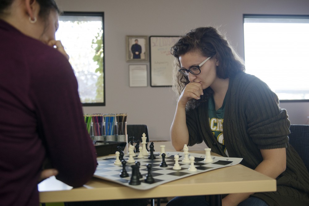 Law students Jessica Szuminski and Makenzie Krause play a game of chess on Friday, Oct. 12, in Mondale Hall. The therapy room that they are in offers law students the chance to unwind without the distractions of technology or homework. 
