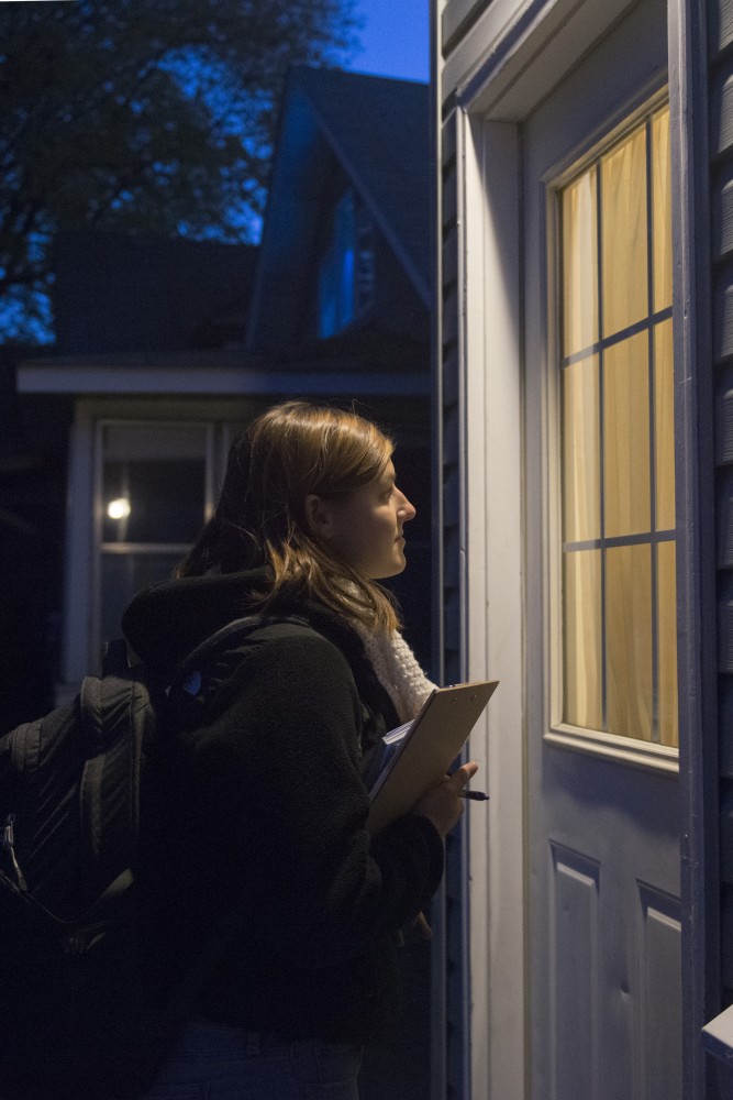 Campus Organizer with the DFL Youth-Coordinated Campaign, Michaela Muza, waits for a resident of a Como home to answer the door on Tuesday, Oct. 23 during a door knocking session.