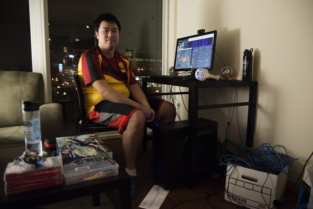 James Han poses at his desk before a game of Overwatch with the University ESports team on Sunday, Oct. 28. The team engages in competitive play once a week against schools from across the country. 