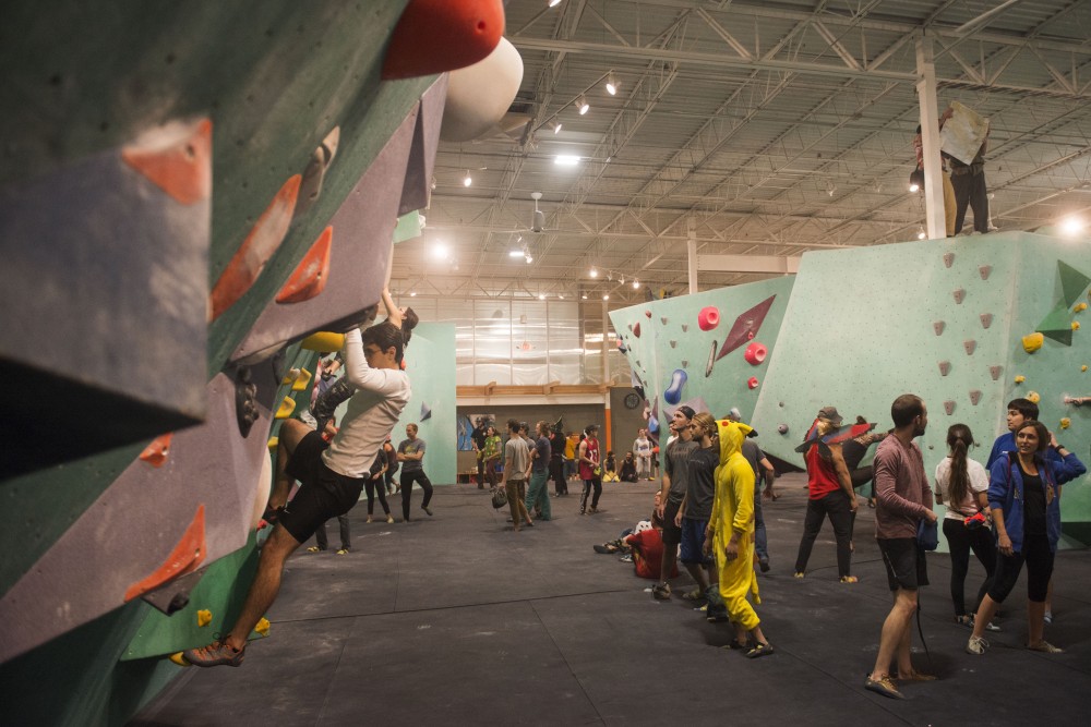 Costumed and normally clothed climbers wait in line at the Minneapolis Bouldering Project on Wednesday, Oct. 31 for a Halloween party.