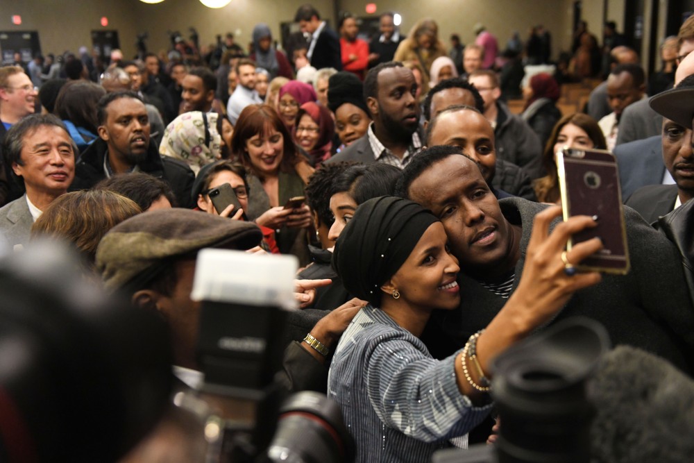 Ilhan Omar takes a photo with a supporter during her election party in Minneapolis on Tuesday, Nov. 6. 