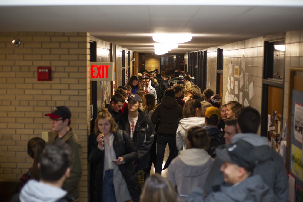 Students wait in line that wraps around the inside of the University Lutheran Church polling place on Tuesday, Nov. 6 in Dinkytown. Students said the wait was as long as two hours.
