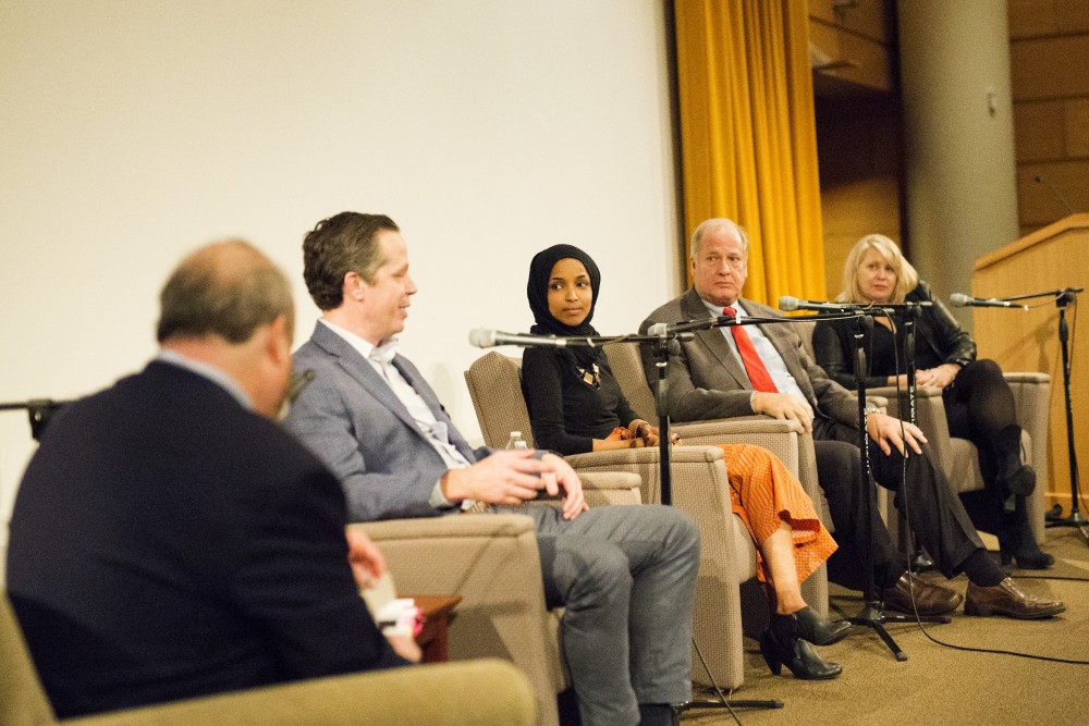 Ben Golnik, Ilhan Omar, Denise Cardinal and Vin Weber converse at the Post-Election Analysis event at the Humphrey School of Public Affairs on Wednesday, Nov. 6. The event took place the night after midterm elections to discuss what happened and the state of Minnesota. 
