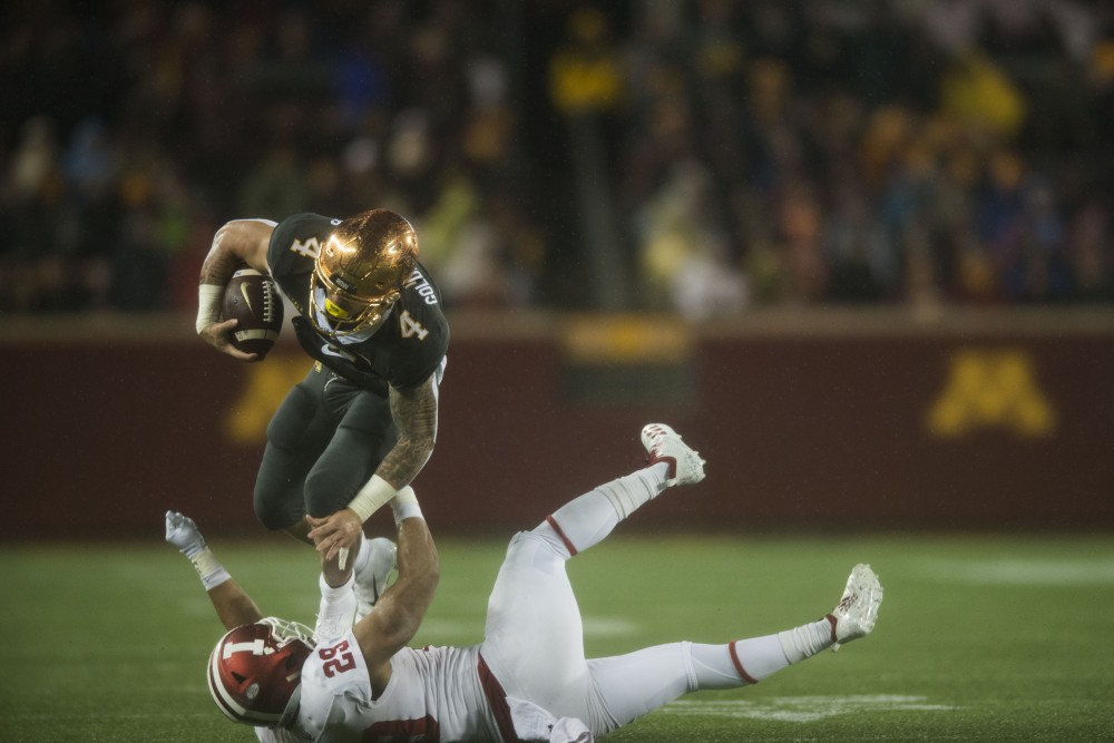 Running back Shannon Brooks jumps over the defender during the game on Friday, Oct. 26 at TCF Bank Stadium. The Gophers won 38-31 with a late touchdown by wide receiver Rashod Bateman.