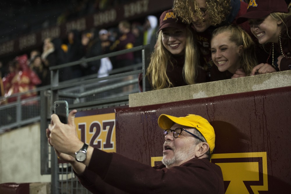 President Eric Kaler takes a selfie with fans. The Gophers won 38-31.