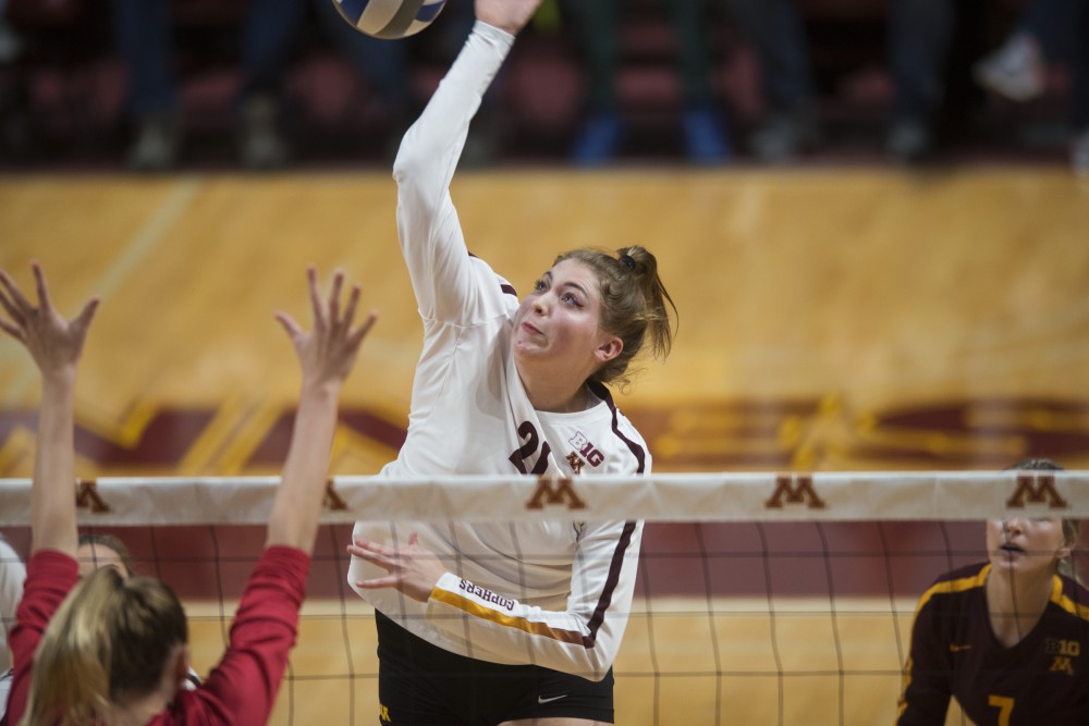 Redshirt Sophomore Regan Pittman jumps to spike the ball at Maturi Pavilion on Friday, Nov. 9. The Gophers swept Indiana in all three sets.