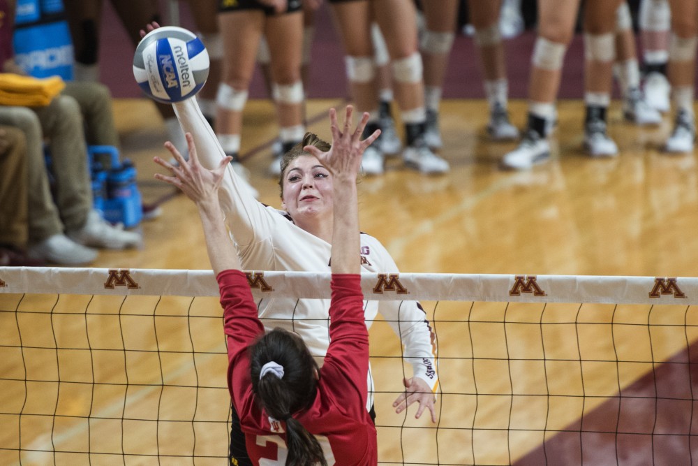 Redshirt Sophomore Regan Pittman jumps to spike the ball at Maturi Pavilion on Friday, Nov. 9. The Gophers swept Indiana in all three sets.