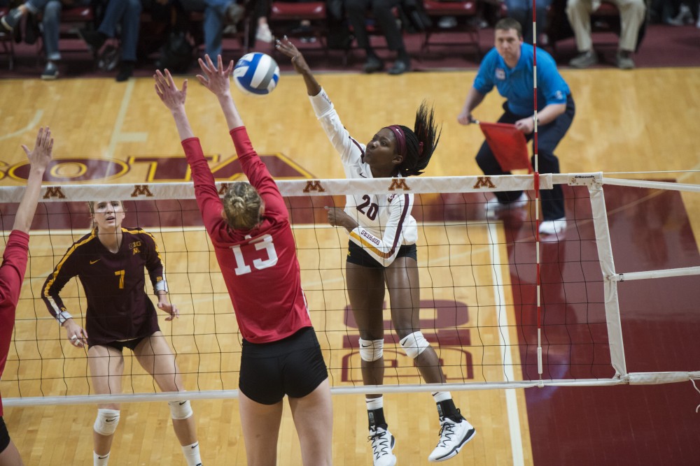 Freshman Adanna Rollins jumps to spike the ball at Maturi Pavilion on Friday, Nov. 9. The Gophers swept Indiana in all three sets.