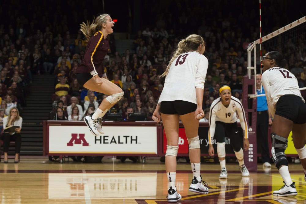 The Gophers celebrate a scored point at Maturi Pavilion on Friday, Nov. 9. The Gophers swept Indiana in all three sets.
