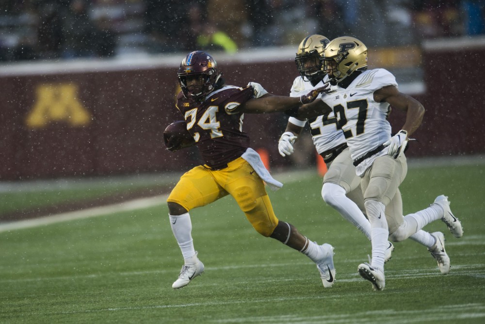Runningback Mohamed Ibrahim stiff arms the defender on a long run on Saturday, Nov. 10 at TCF Bank Stadium. The Gophers beat Purdue 41-10. Ibrahim finished with 155 rushing yards.