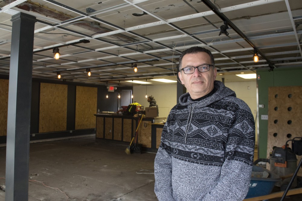 Owner of Wallys and Hideaway, Wally Sakallah, stands in the doorway of the space that was to be Cosmic Bean Dispensary. Construction is currently underway inside the building, which is next to Hideaway. 