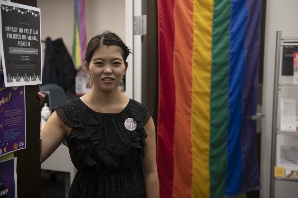 Haruka Yukioka, relations manager of the Queer Student Cultural Center, poses for a photo outside of the centers room in Coffman Memorial Union on Tuesday, Oct. 30. 