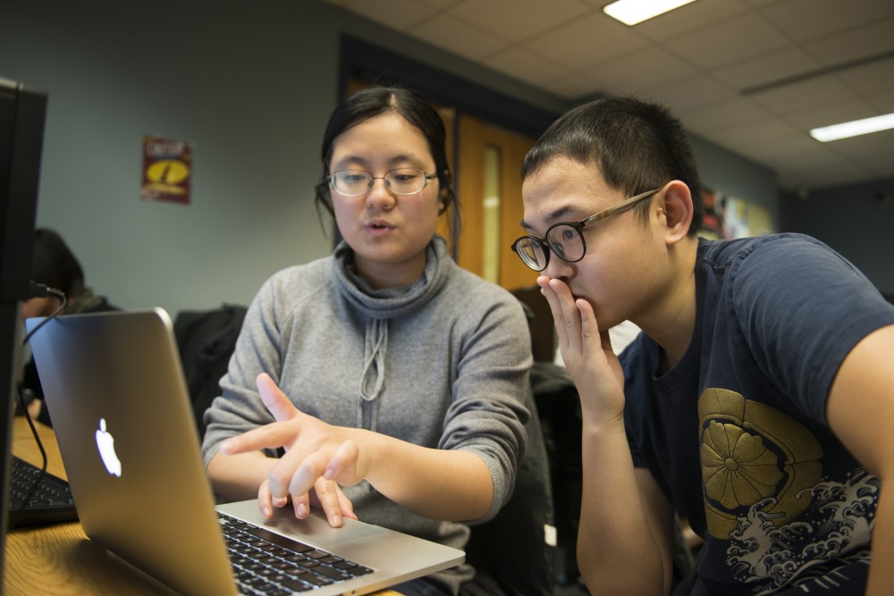 Violet Chang, left, has office hours with one of her students, Yifan Jing, at Keller Hall on Tuesday, Nov. 13. Chang is a computer science undergraduate student who teaches three courses.